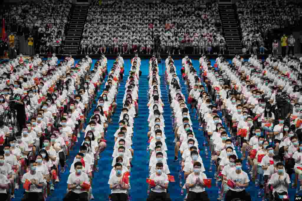 More than 7,000 students at the Huazhong University of Science and Technology attend a commencement ceremony in a gymnasium in Wuhan, in China's central Hubei province.