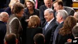 Israeli Prime Minister Benjamin Netanyahu, accompanied by House Majority Leader Kevin McCarthy of Calif., is greeted before addressing a joint meeting of Congress on Capitol Hill in Washington, Tuesday, March 3, 2015. 