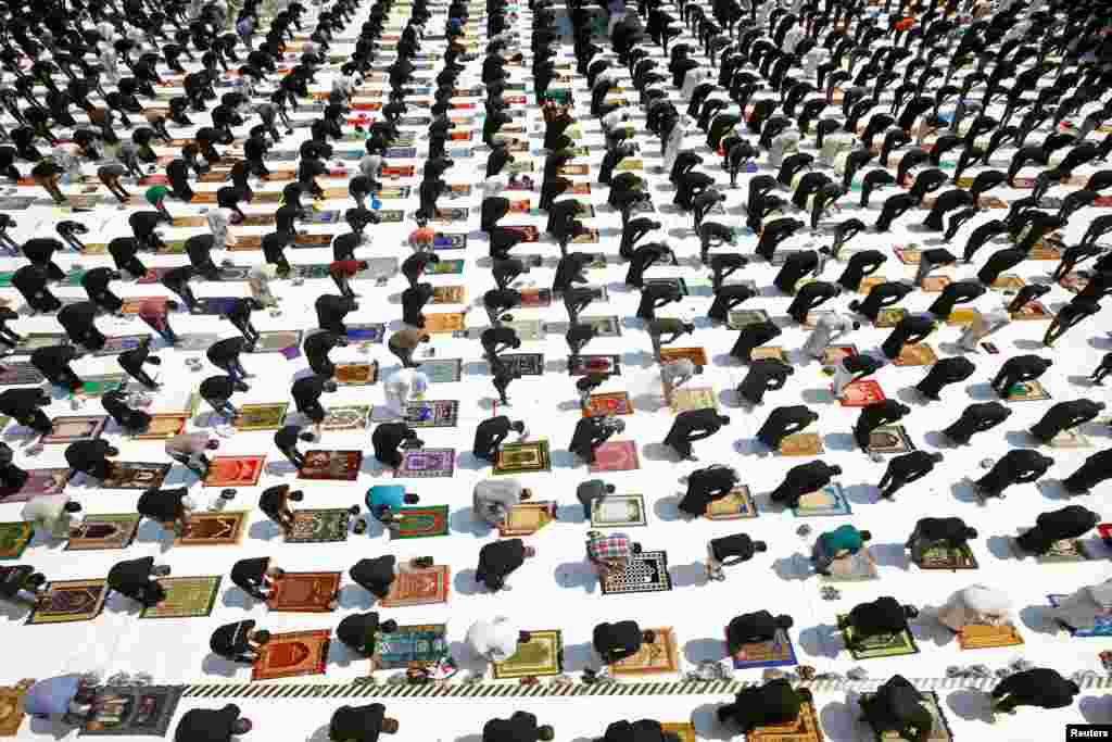 Supporters of Iraqi Shi'ite cleric Moqtada al-Sadr maintain social distancing as they attend Friday prayers for the first time in months since the coronavirus restrictions were imposed, in Kufa mosque, near Najaf, Iraq.